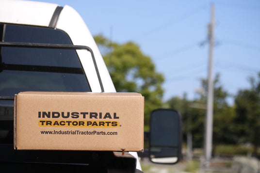 Industrial Tractor Parts branded shipping carton loaded on a service truck — nationwide parts delivery from ITP's nine U.S. branches"