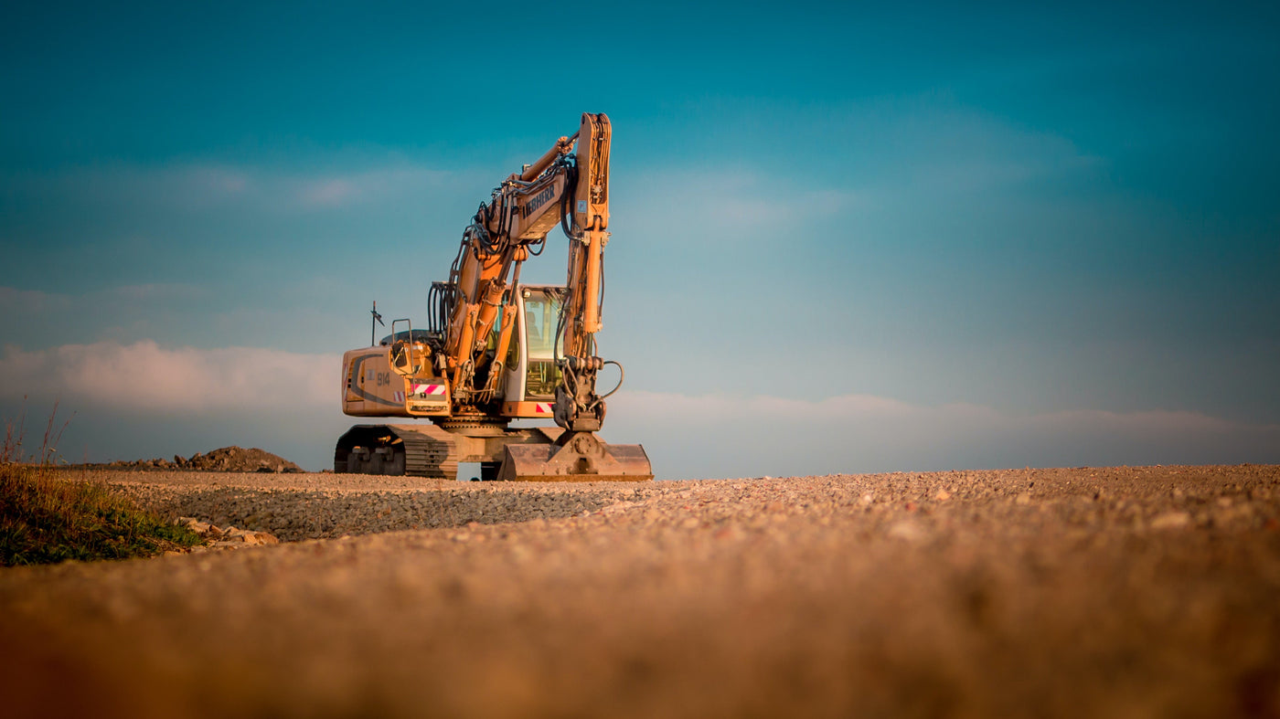 Excavator on a construction site with a clear sky